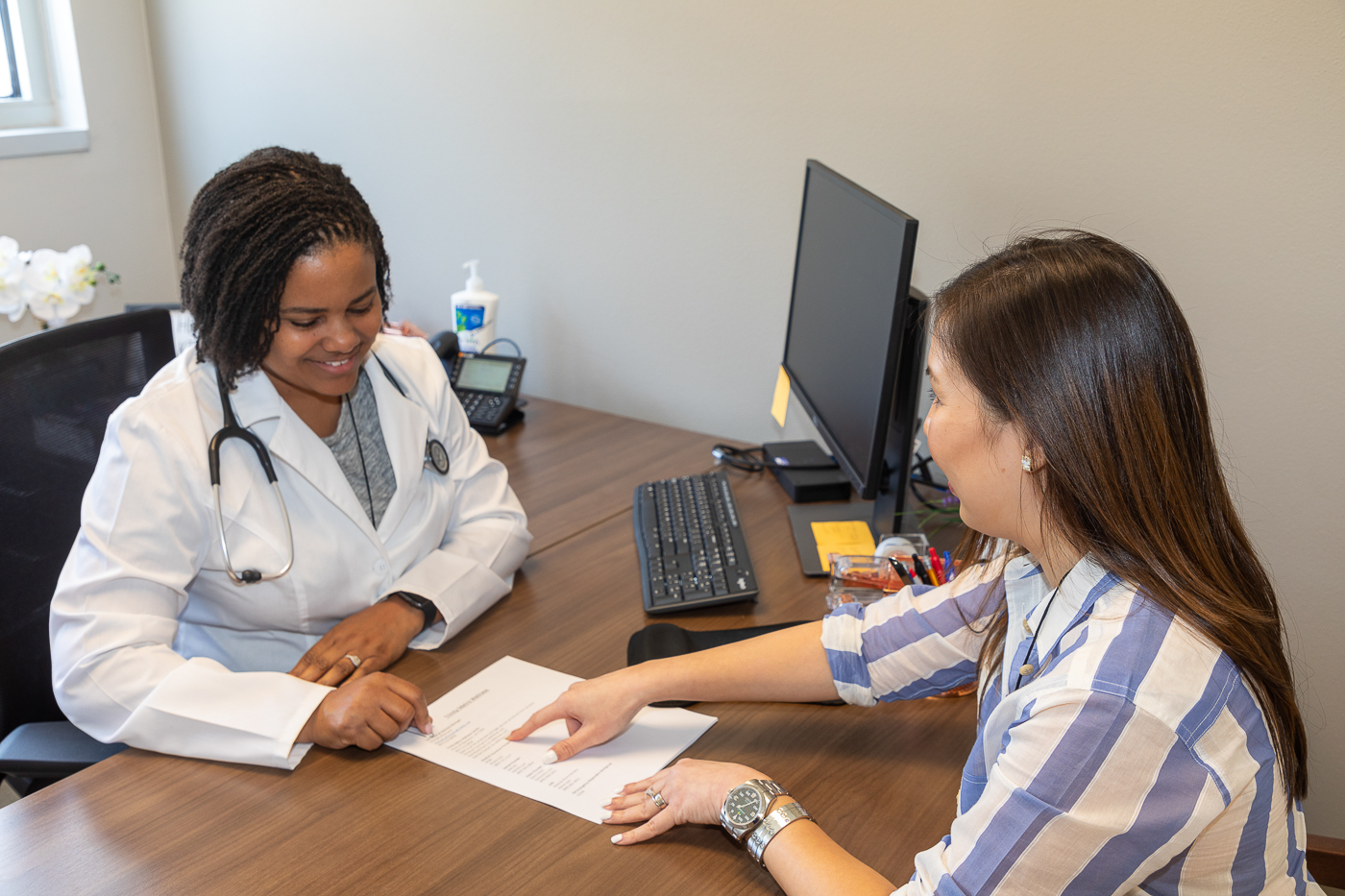 Doctor with patient as Medical Clinic offices